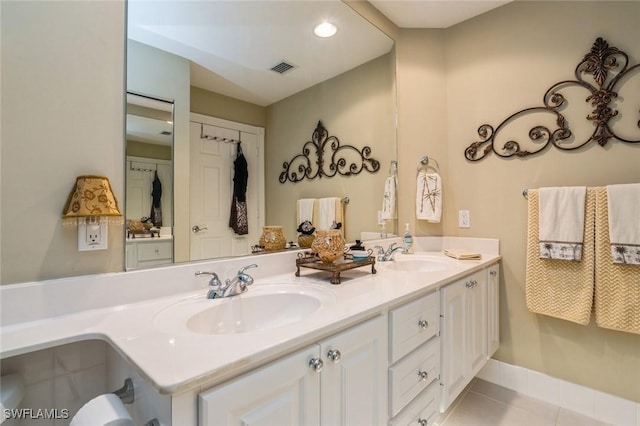 full bath featuring double vanity, visible vents, a sink, and tile patterned floors