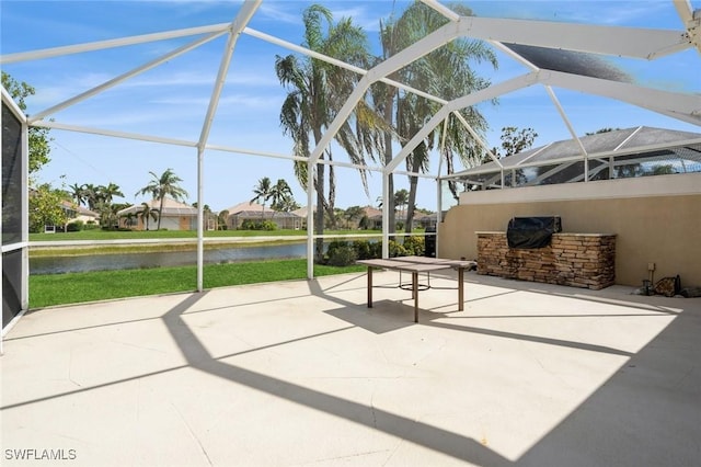 sunroom featuring a water view