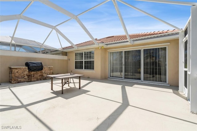 view of patio / terrace featuring glass enclosure