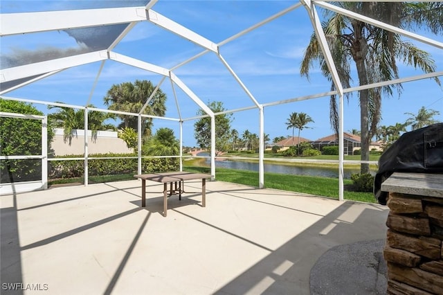 view of patio / terrace with a water view and a lanai