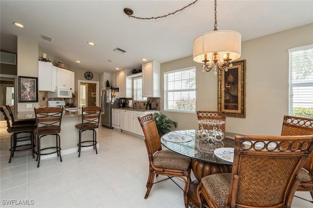 dining space with plenty of natural light, visible vents, and recessed lighting