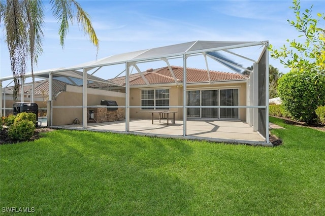 back of property featuring a lanai, a patio, a lawn, and stucco siding