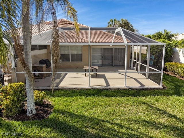 back of house with glass enclosure, a patio area, a tile roof, and stucco siding