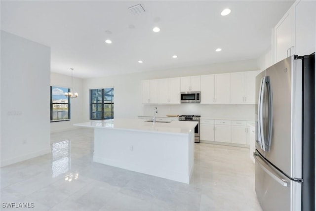 kitchen with a sink, appliances with stainless steel finishes, recessed lighting, and white cabinetry