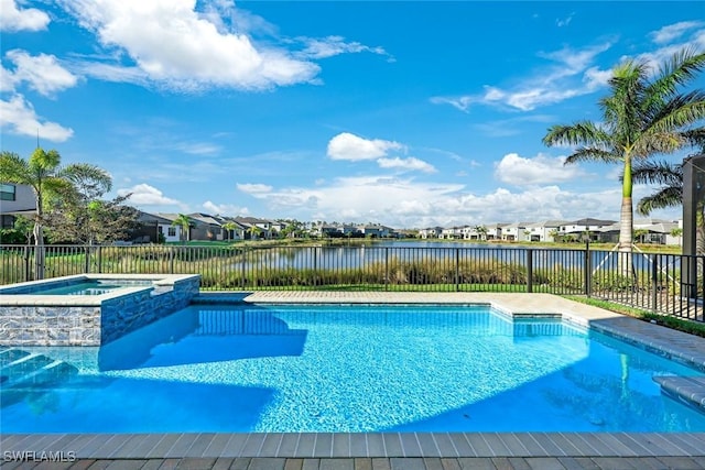 view of swimming pool with a residential view, a water view, and fence