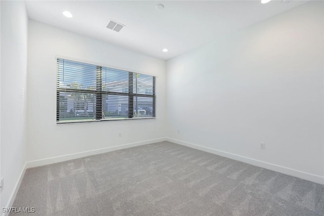 spare room with recessed lighting, visible vents, carpet floors, and baseboards