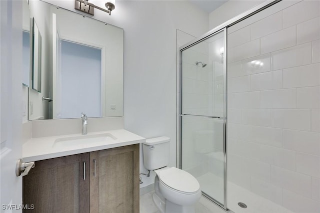 full bath with a stall shower, toilet, and vanity