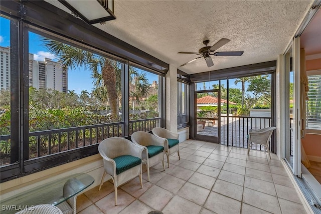 sunroom featuring ceiling fan