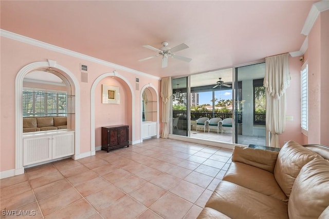 unfurnished living room featuring light tile patterned floors, baseboards, visible vents, and crown molding