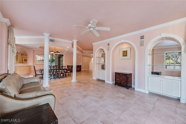 living room featuring visible vents, ornamental molding, light tile patterned flooring, ornate columns, and ceiling fan with notable chandelier