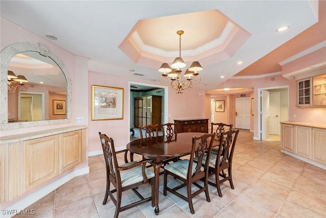 dining area with arched walkways, ornamental molding, light tile patterned floors, and a raised ceiling