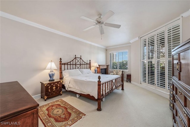 bedroom with a ceiling fan, carpet, baseboards, and crown molding