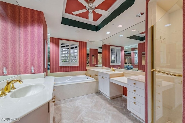 full bathroom with a stall shower, a tray ceiling, a garden tub, and a sink