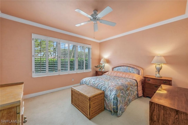 carpeted bedroom featuring crown molding, baseboards, and ceiling fan