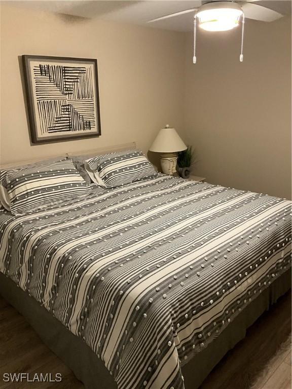 bedroom with dark wood-type flooring and ceiling fan