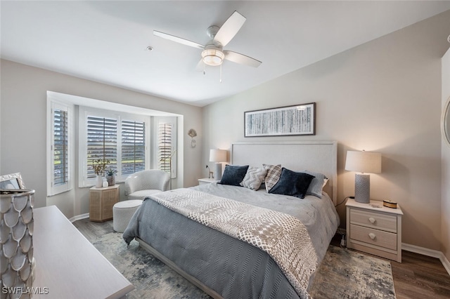 bedroom featuring a ceiling fan, baseboards, and wood finished floors