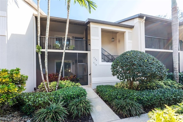 entrance to property featuring stucco siding