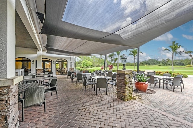 view of patio with golf course view and outdoor dining area