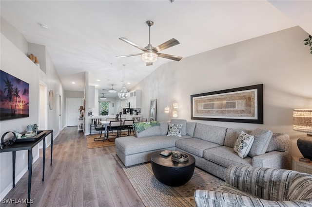 living room featuring ceiling fan, lofted ceiling, recessed lighting, wood finished floors, and baseboards