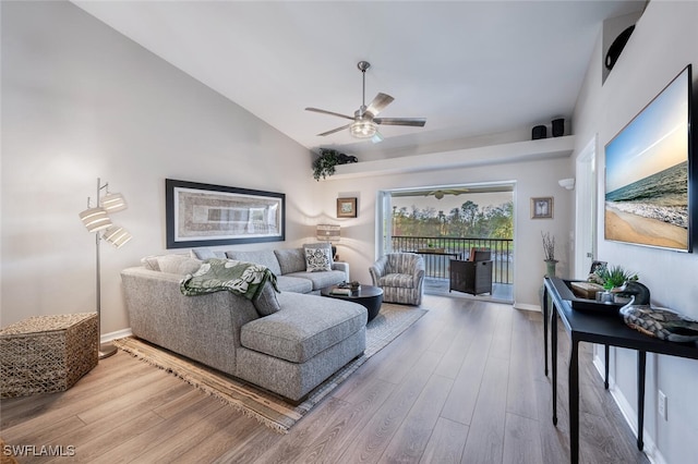 living room featuring high vaulted ceiling, baseboards, a ceiling fan, and wood finished floors