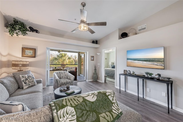 living area featuring baseboards, visible vents, lofted ceiling, ceiling fan, and wood finished floors