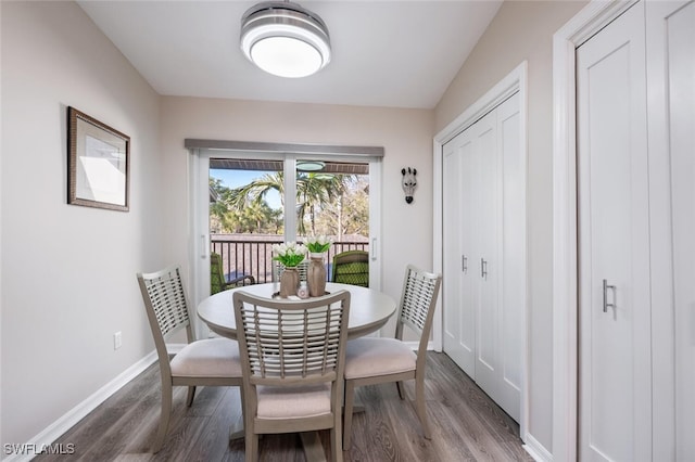 dining area featuring dark wood-style floors and baseboards