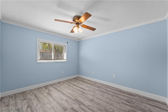 unfurnished room featuring crown molding, wood finished floors, baseboards, and ceiling fan