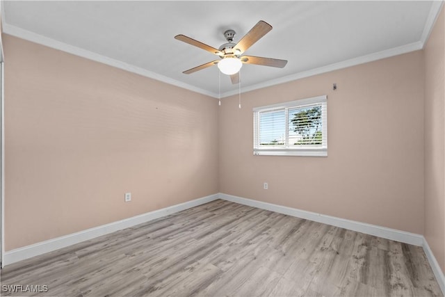 spare room featuring light wood-style flooring, baseboards, crown molding, and a ceiling fan