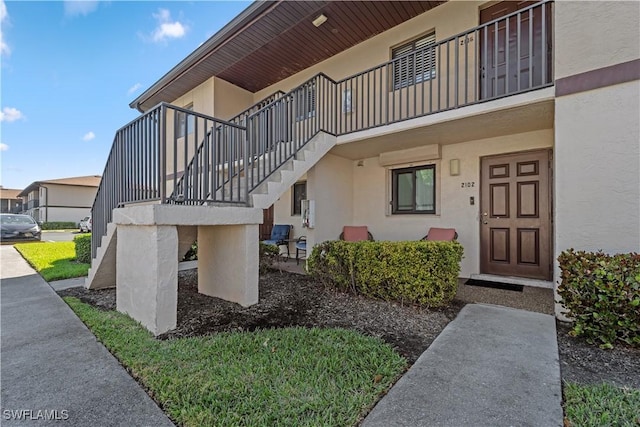 property entrance with stucco siding