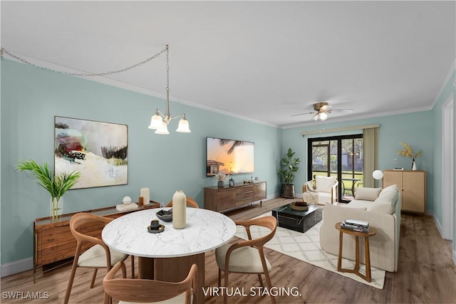 dining area featuring crown molding, wood finished floors, and baseboards