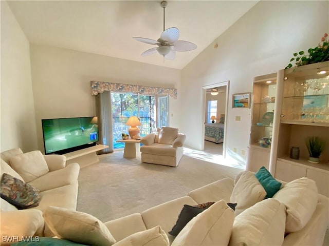 carpeted living room with high vaulted ceiling and a ceiling fan