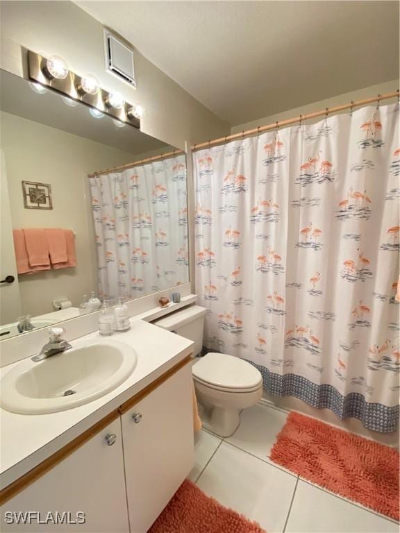 bathroom featuring toilet, curtained shower, vanity, and tile patterned floors