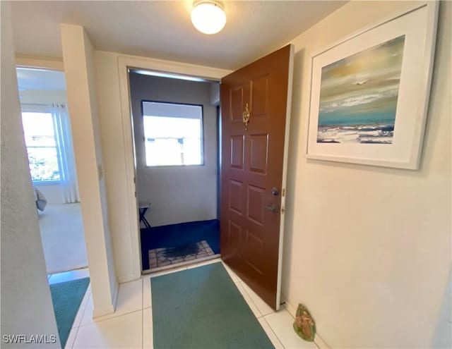 doorway with light tile patterned floors