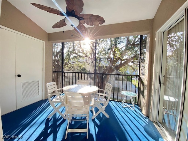 exterior space featuring a ceiling fan, lofted ceiling, and visible vents