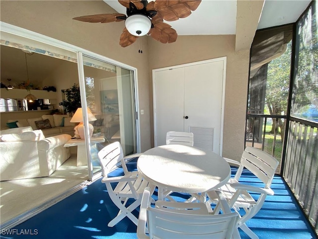 sunroom / solarium with a ceiling fan