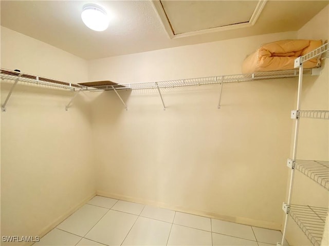 walk in closet with light tile patterned floors