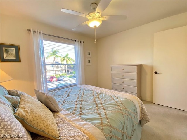 bedroom with light carpet and ceiling fan