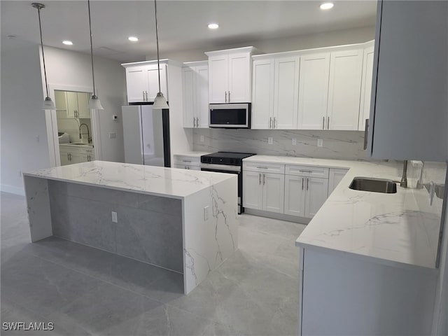 kitchen featuring decorative light fixtures, stainless steel microwave, electric range, white cabinets, and light stone countertops