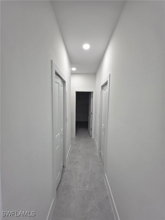 corridor featuring baseboards