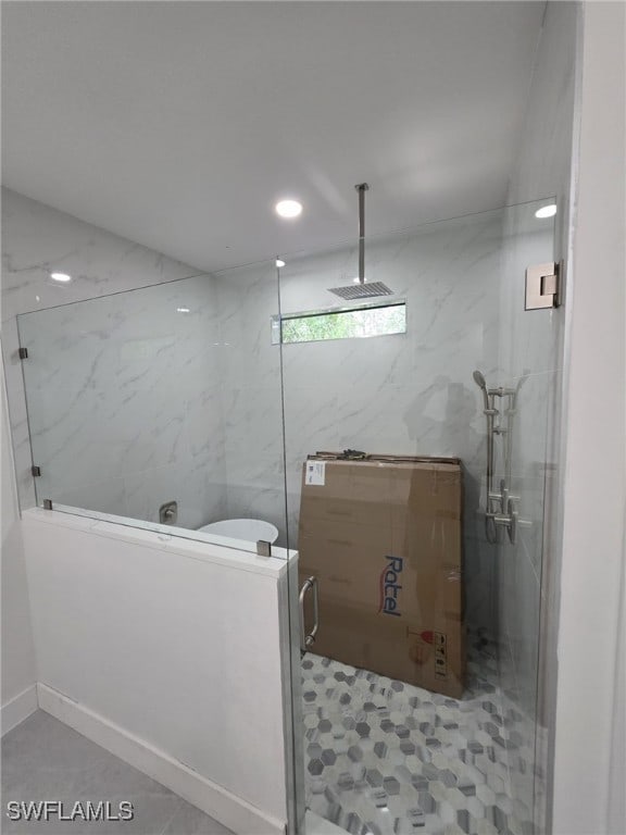 bathroom featuring recessed lighting, tile walls, and walk in shower