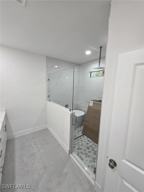 bathroom with a marble finish shower, recessed lighting, a soaking tub, vanity, and baseboards