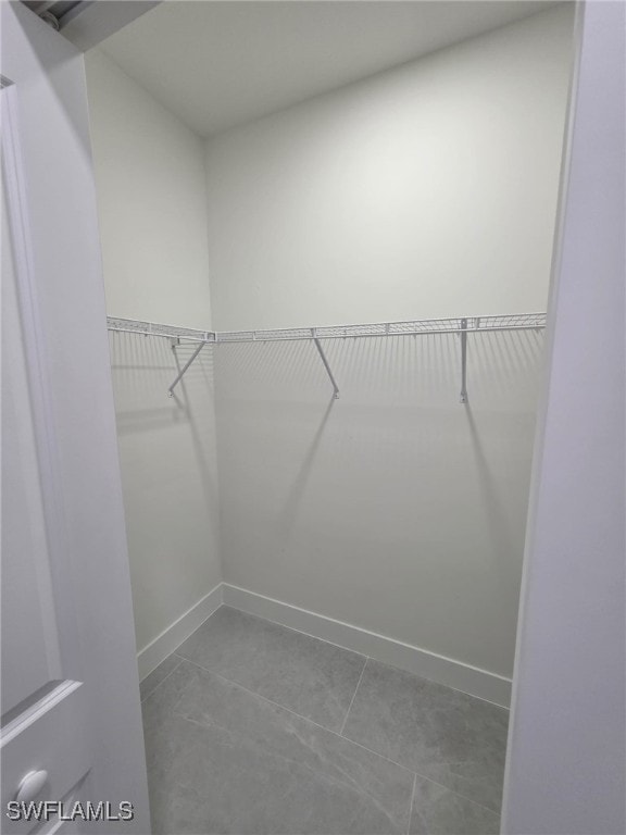 walk in closet with tile patterned floors