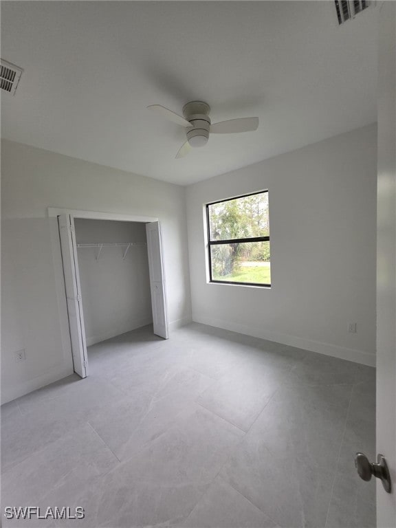 unfurnished bedroom with a closet, visible vents, ceiling fan, and baseboards