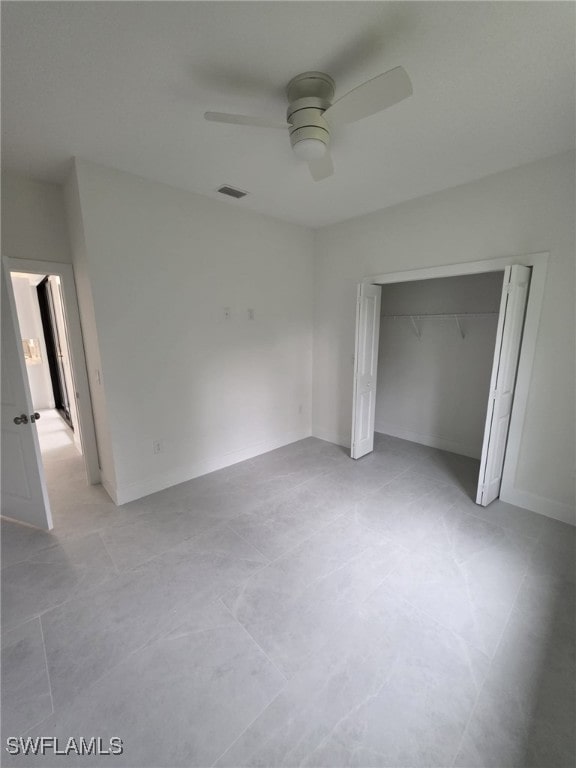 unfurnished bedroom with baseboards, a closet, visible vents, and a ceiling fan