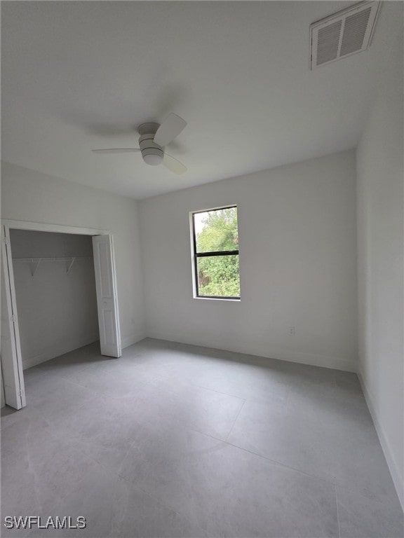 unfurnished bedroom featuring ceiling fan, a closet, visible vents, and baseboards