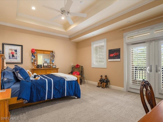 bedroom with crown molding, french doors, a raised ceiling, and access to exterior