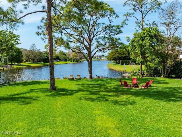 view of yard featuring an outdoor fire pit and a water view