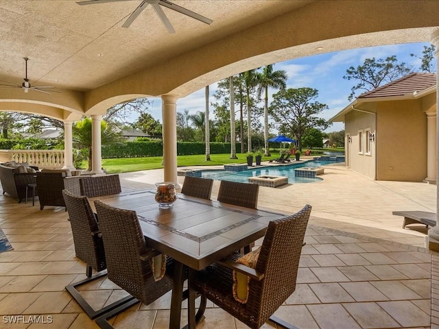 view of patio / terrace featuring outdoor dining area, a ceiling fan, and an outdoor pool