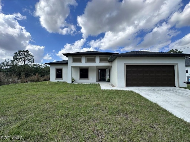 prairie-style home with driveway, a front lawn, an attached garage, and stucco siding