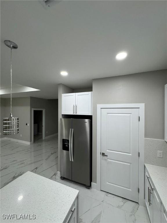 kitchen with recessed lighting, white cabinetry, baseboards, marble finish floor, and stainless steel fridge with ice dispenser